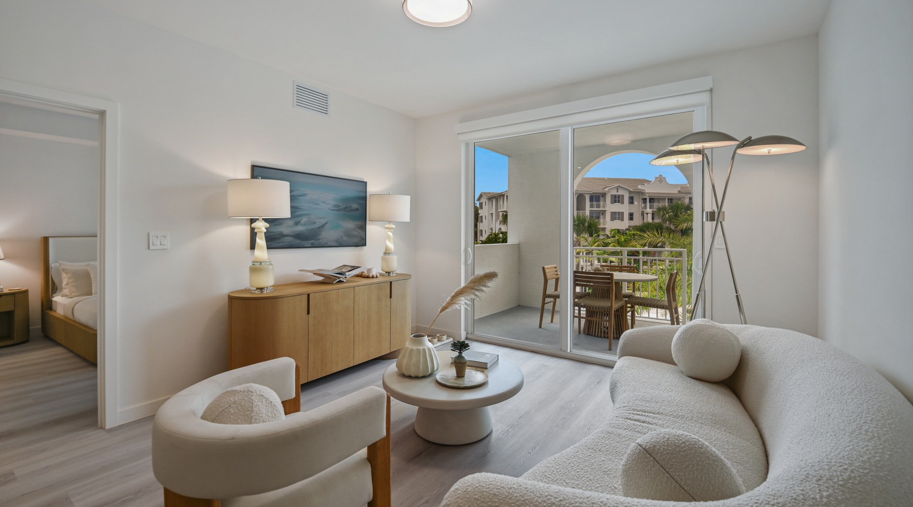 Bedroom with a queen bed, ensuite bath, and walk-in closet at Sereno apartments in Sunrise, FL