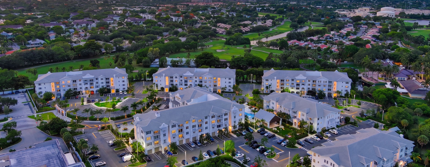 Aerial view of the Sereno apartment community in Sunrise, FL, showing all buildings, the pool, and a nearby golf course
