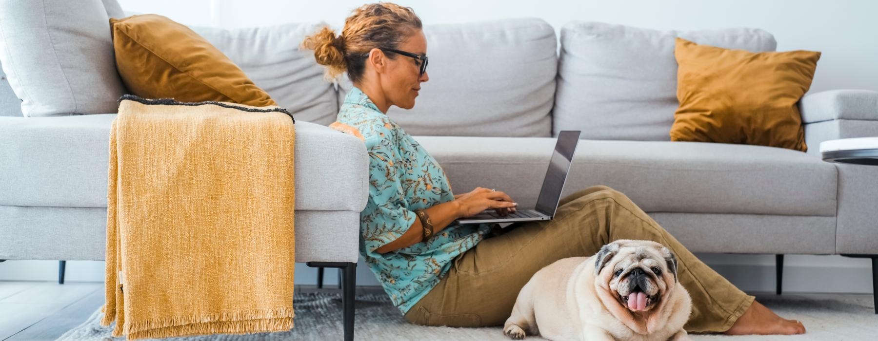 a person sitting on the floor with a dog